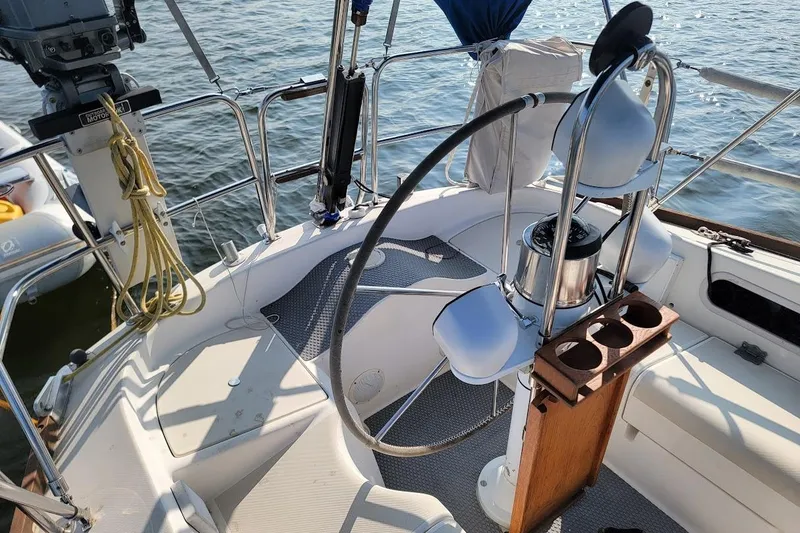 Slide: The Image of Cockpit of 1987 Pearson 39-2 sailboat with 2016 Beta engine, featuring steering wheel and cup holders. - 23