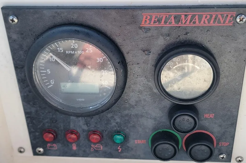 Slide: The Image of Control panel of a 1987 Pearson 39-2 with 2016 Beta engine, featuring gauges and buttons. - 29