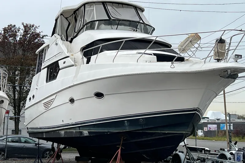 The Image of 2002 Silverton 453 Motor Yacht on dry dock, showcasing sleek design and spacious cabin. - 0