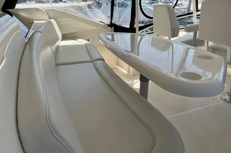 Slide: The Image of Interior of 2002 Silverton 453 Motor Yacht with white seating and table. - 10