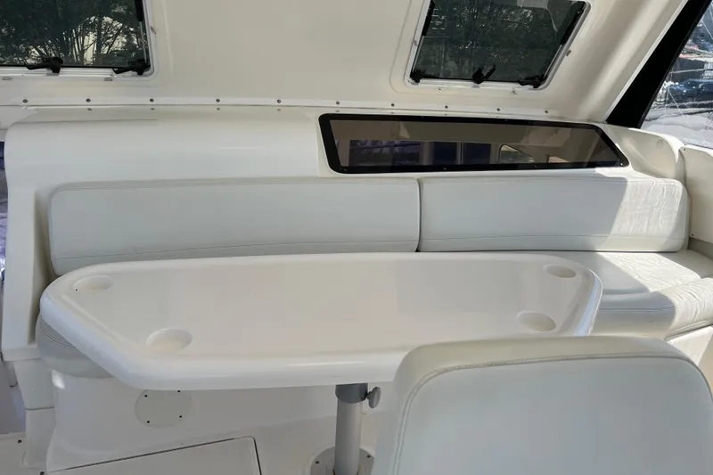 Slide: The Image of Interior of 2002 Silverton 453 Motor Yacht with white seating and table. - 11