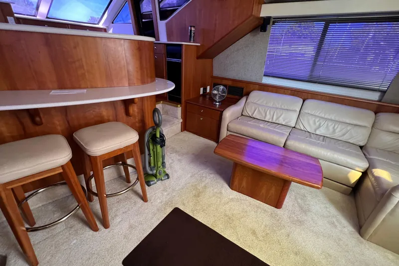 Slide: The Image of Interior of 2002 Silverton 453 Motor Yacht with seating, table, and bar stools. - 21