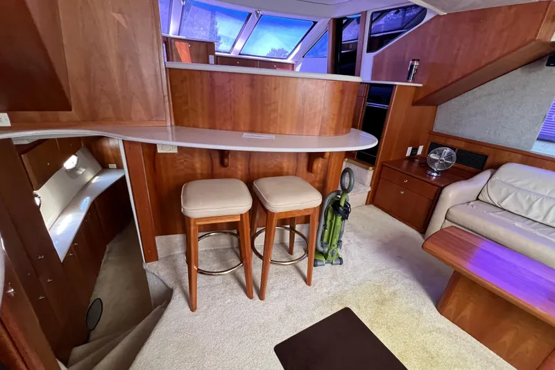 Slide: The Image of Interior of 2002 Silverton 453 Motor Yacht with bar stools and cozy seating area. - 22