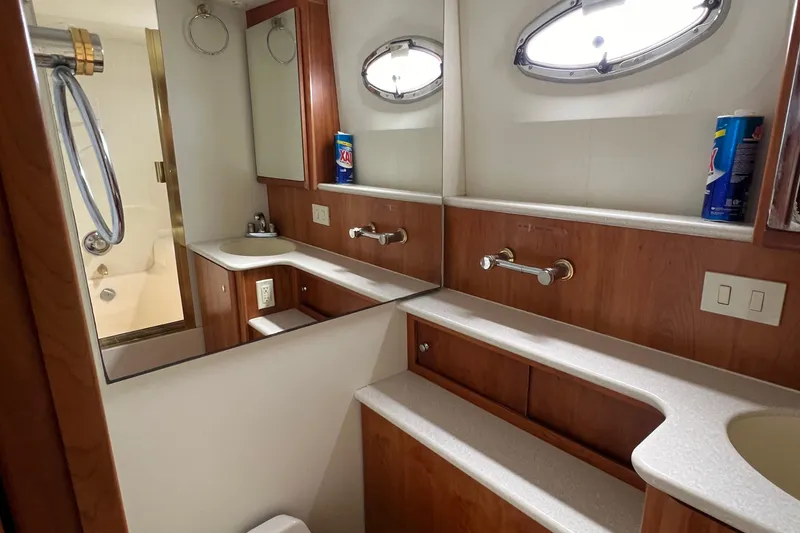 Slide: The Image of Luxurious bathroom in 2002 Silverton 453 Motor Yacht with wood accents and modern fixtures. - 27
