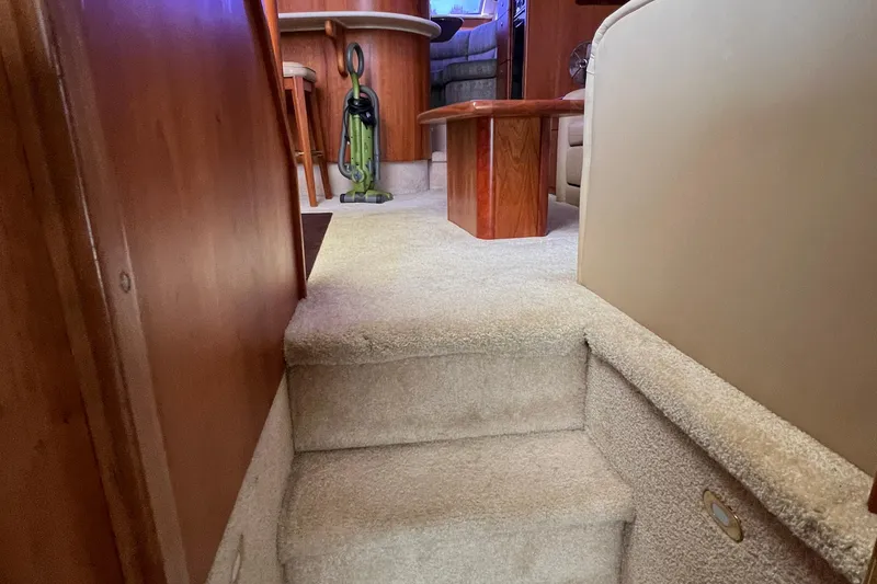 Slide: The Image of Interior of 2002 Silverton 453 Motor Yacht with carpeted stairs and wooden furniture. - 29