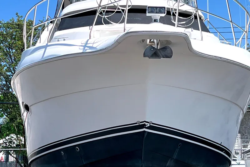 Slide: The Image of 2002 Silverton 453 Motor Yacht, front view, docked with clear blue sky background. - 3