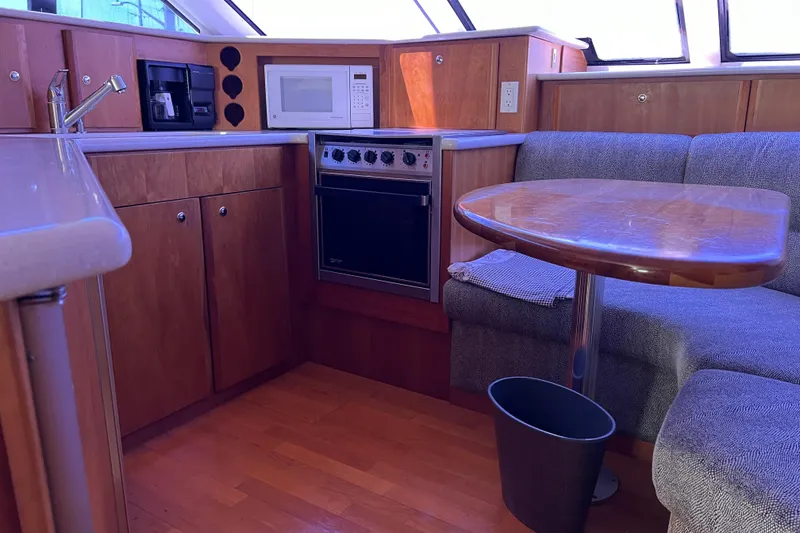 Slide: The Image of Interior of 2002 Silverton 453 Motor Yacht with kitchen and dining area. - 30