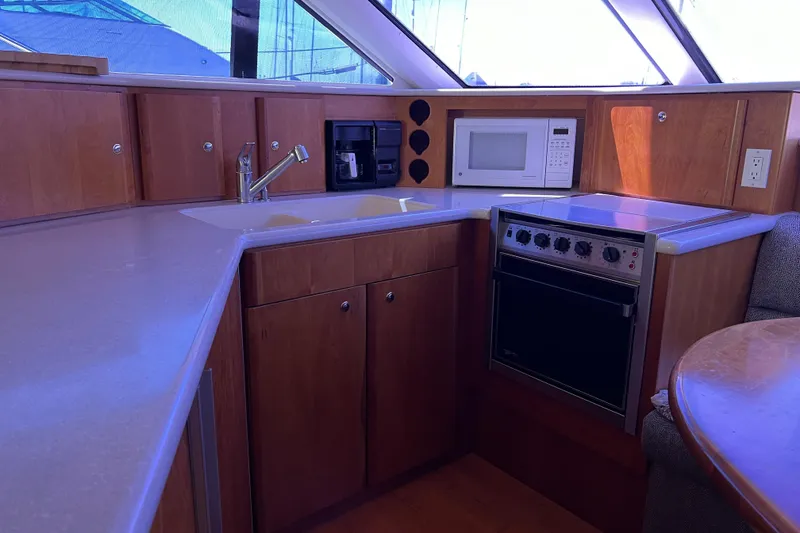 Slide: The Image of Luxurious kitchen area in a 2002 Silverton 453 Motor Yacht with modern appliances. - 31
