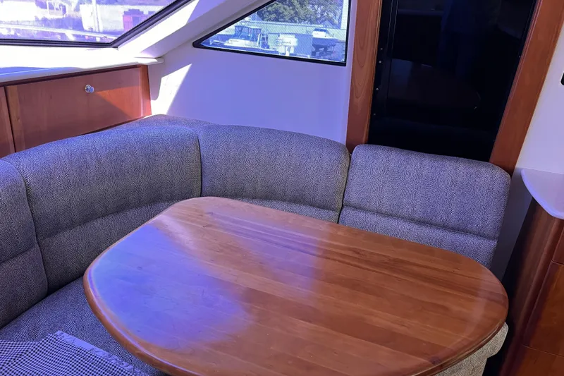 Slide: The Image of Interior of 2002 Silverton 453 Motor Yacht with cozy seating and wooden table. - 32