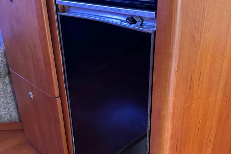 Slide: The Image of Wooden cabinetry and black appliance in 2002 Silverton 453 Motor Yacht interior. - 33