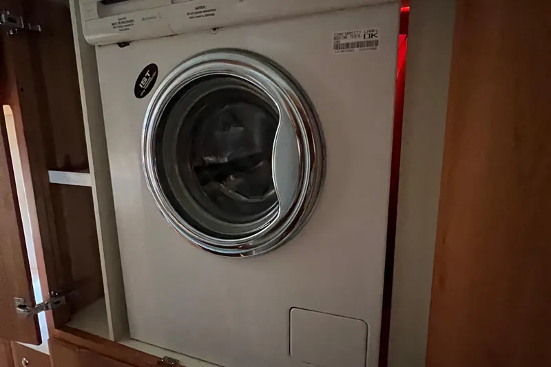 Slide: The Image of Washing machine inside 2002 Silverton 453 Motor Yacht, wooden cabinetry surrounding. - 39