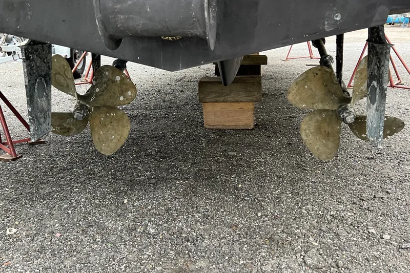 Slide: The Image of 2002 Silverton 453 Motor Yacht propellers on dry dock, showing dual propeller system. - 4