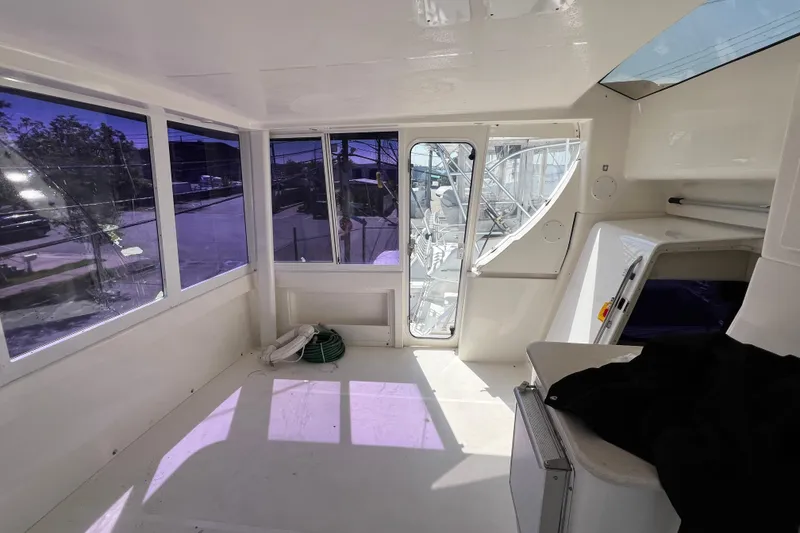Slide: The Image of 2002 Silverton 453 Motor Yacht interior with large windows and bright, spacious cabin. - 6