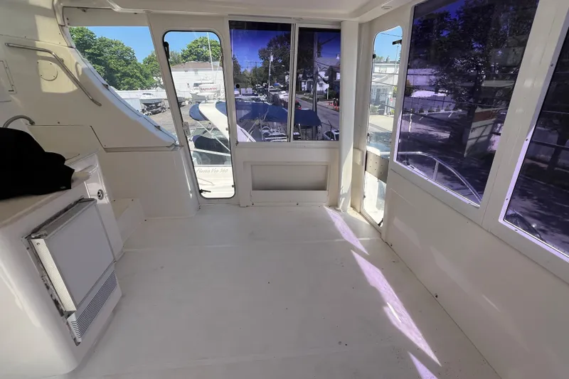 Slide: The Image of Interior view of 2002 Silverton 453 Motor Yacht with spacious cabin and large windows. - 7