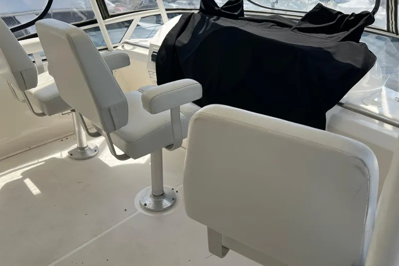 Slide: The Image of Interior of 2002 Silverton 453 Motor Yacht with white seating and covered console. - 9