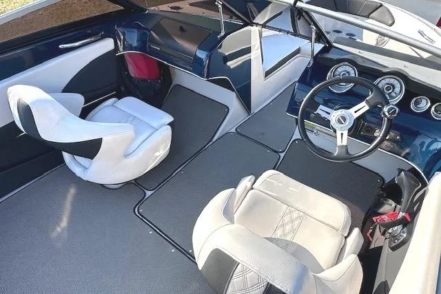 Slide: The Image of 2017 Glastron GT 205 boat interior with modern dashboard and comfortable seating. - 11