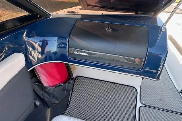 Slide: The Image of Interior of a 2017 Glastron GT 205 boat, featuring sleek design and storage compartments. - 18