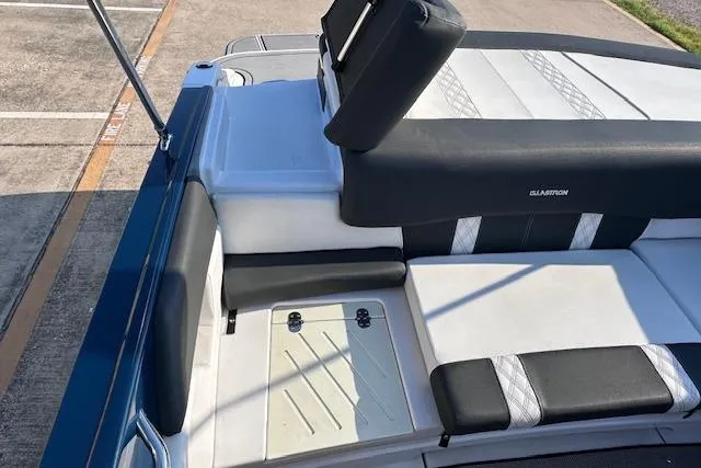 Slide: The Image of 2017 Glastron GT 205 boat interior with cushioned seating and storage area. - 19