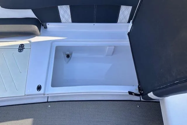 Slide: The Image of 2017 Glastron GT 205 boat interior storage compartment with open lid. - 22