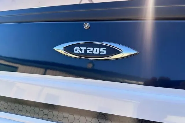 Slide: The Image of 2017 Glastron GT 205 boat emblem on blue and white exterior. - 27