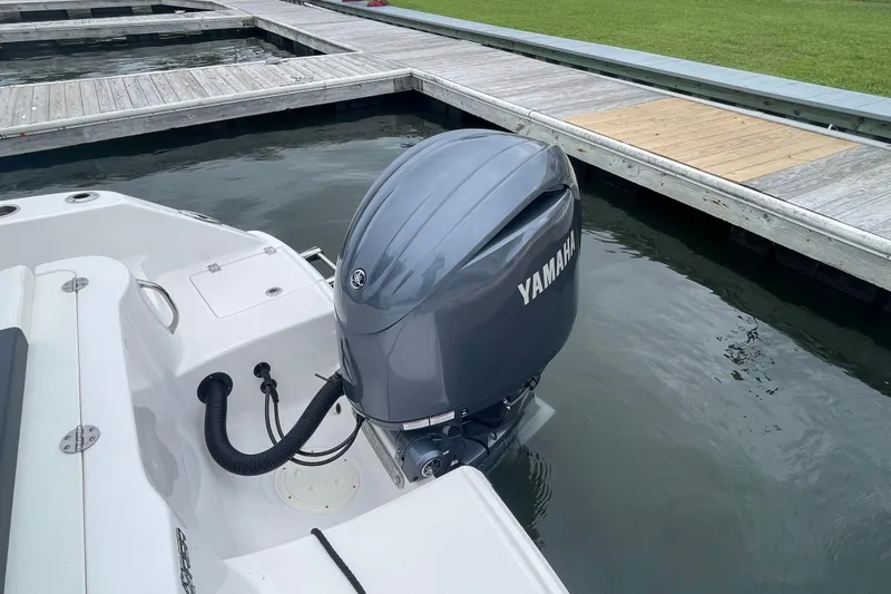 Slide: The Image of 2024 Robalo R202 Explorer with Yamaha outboard engine at dock. - 11