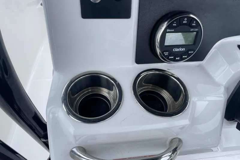 Slide: The Image of 2024 Robalo R202 Explorer dashboard with cup holders and Clarion audio system. - 19