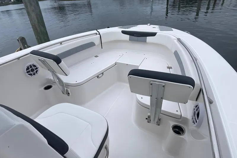 Slide: The Image of 2024 Robalo R202 Explorer boat interior with seating and cup holders. - 21