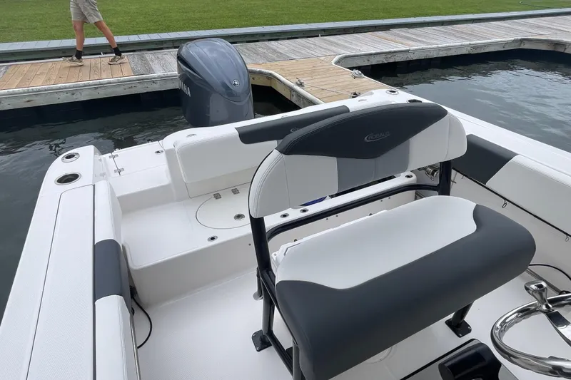 Slide: The Image of 2024 Robalo R202 Explorer boat interior with seating and Yamaha engine at dock. - 22