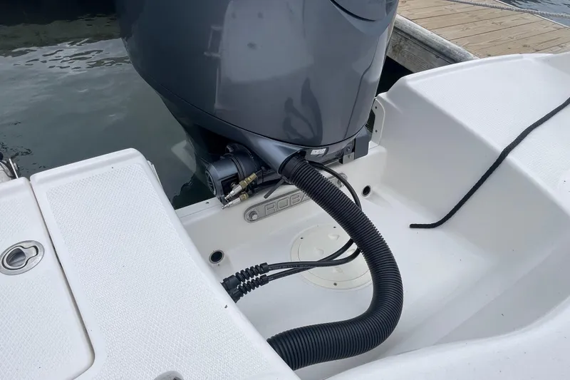 Slide: The Image of 2024 Robalo R202 Explorer boat engine and deck detail at dock. - 24