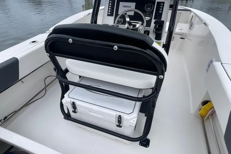 Slide: The Image of 2024 Robalo R202 Explorer boat interior with helm, seating, and storage. - 27