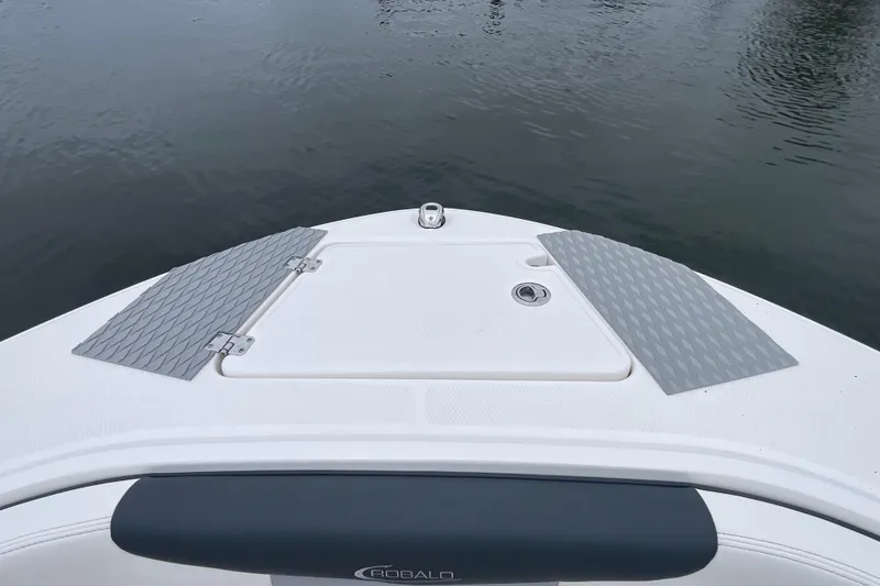 Slide: The Image of 2024 Robalo R202 Explorer boat bow with non-slip pads on calm water. - 29