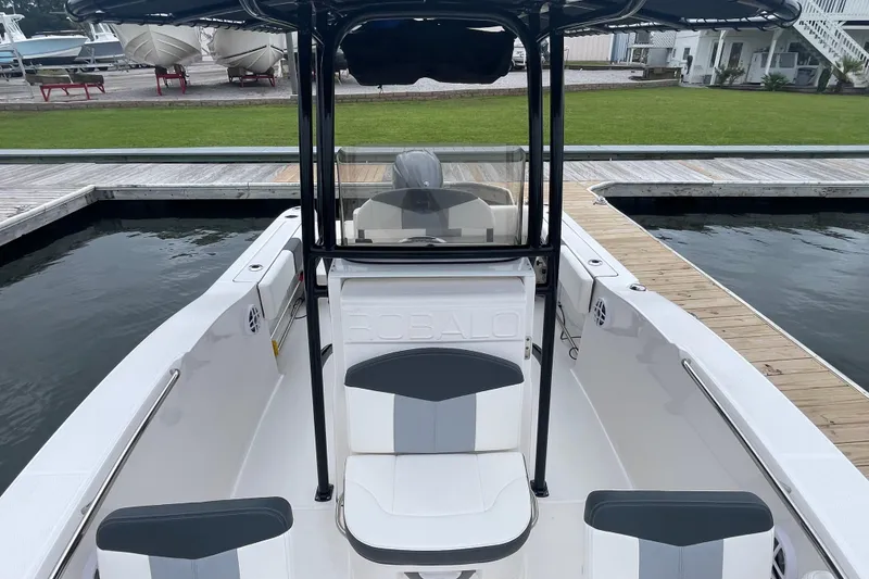 Slide: The Image of 2024 Robalo R202 Explorer boat interior at dock, featuring seating and console. - 31
