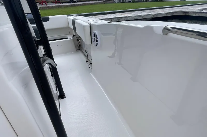 Slide: The Image of 2024 Robalo R202 Explorer boat interior with white seating and stainless steel railings. - 33