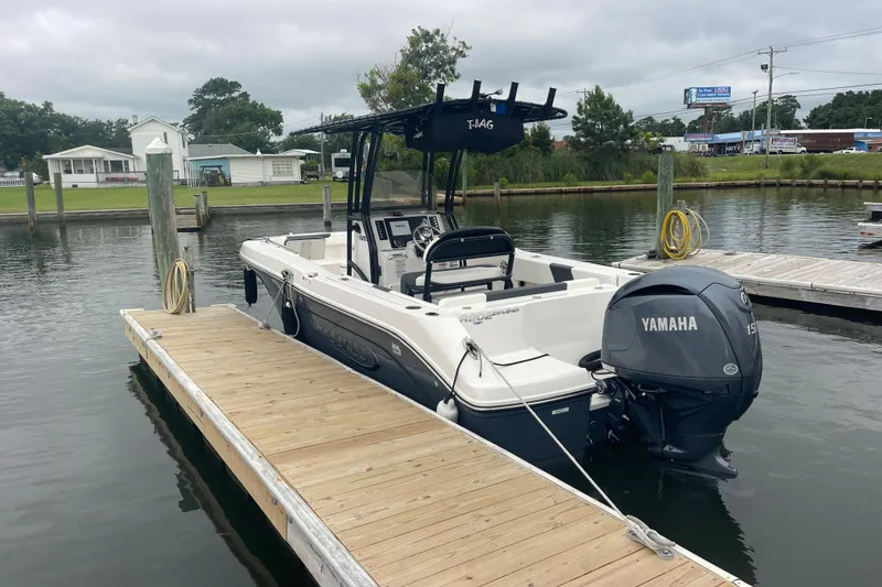 Slide: The Image of 2024 Robalo R202 Explorer boat docked with Yamaha engine, calm water background. - 4