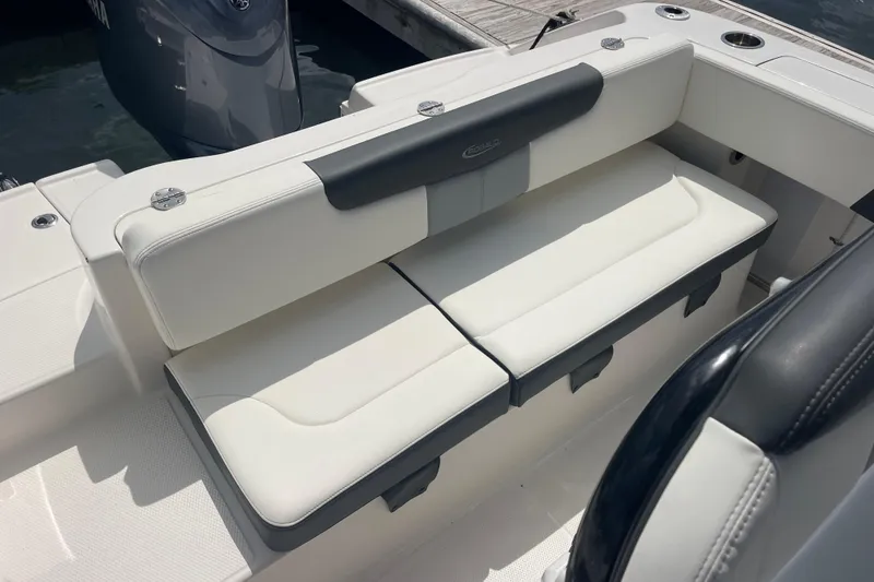 Slide: The Image of 2024 Robalo R202 Explorer boat seating with white cushions and sleek design. - 40