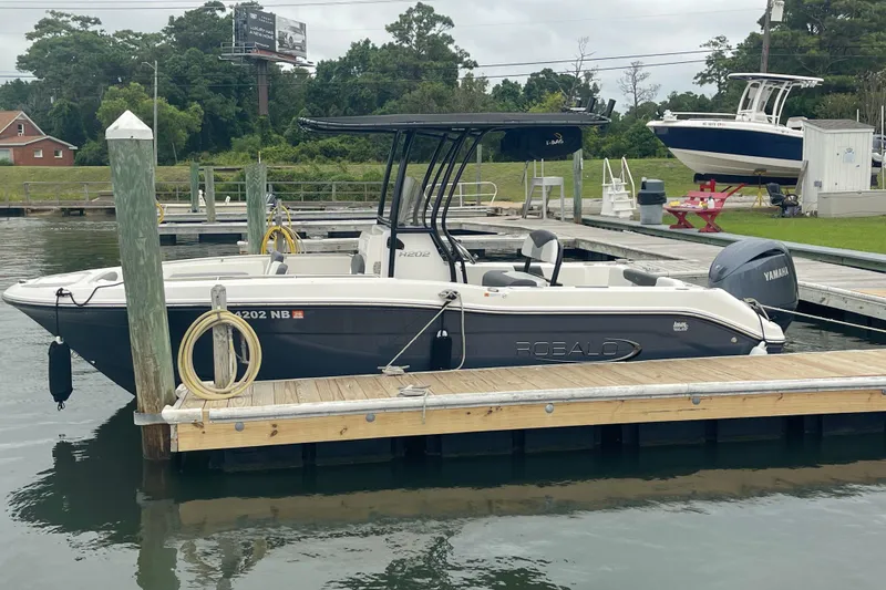 Slide: The Image of 2024 Robalo R202 Explorer boat docked at marina with Yamaha engine. - 7