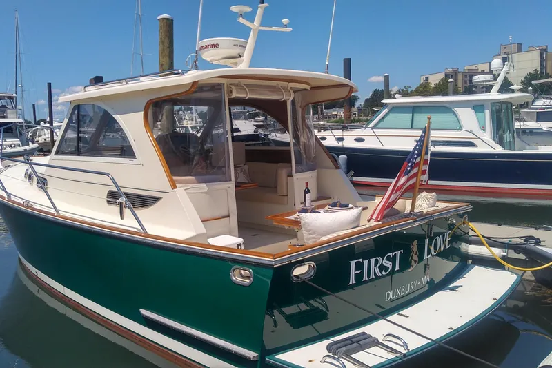 Slide: The Image of 2008 Legacy Yachts 32 docked, featuring "First Love" name and American flag. - 12