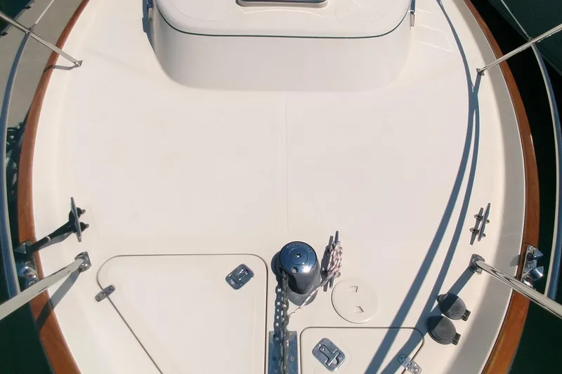 Slide: The Image of 2008 Legacy Yachts 32 deck view with polished fittings and wooden railings. - 18