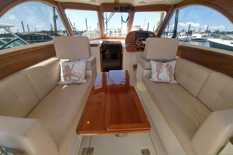 Slide: The Image of Interior of 2008 Legacy Yachts 32 with beige seating and wooden accents. - 24