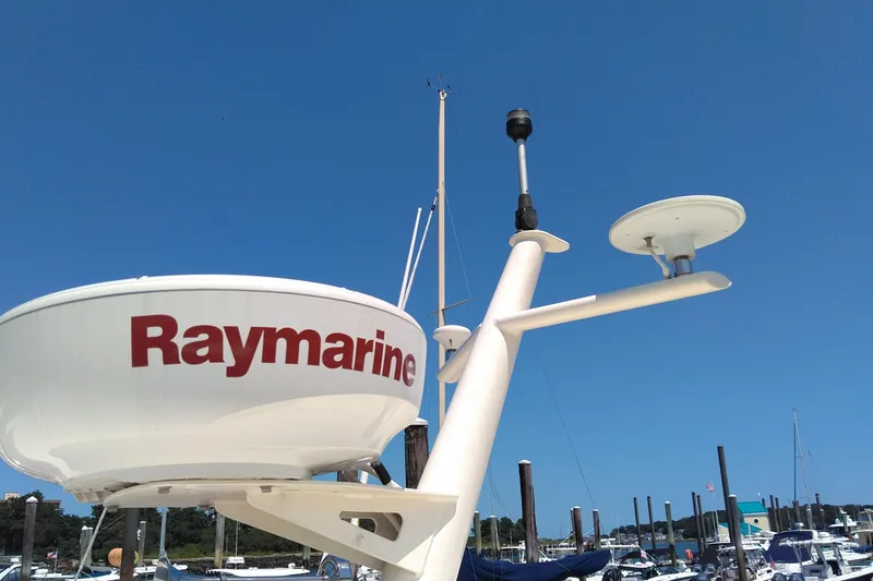 Slide: The Image of Radar equipment on a 2008 Legacy Yachts 32, featuring Raymarine technology against a clear blue sky. - 33