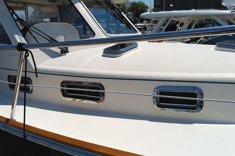 Slide: The Image of 2008 Legacy Yachts 32 boat deck with windows and railing in marina setting. - 35