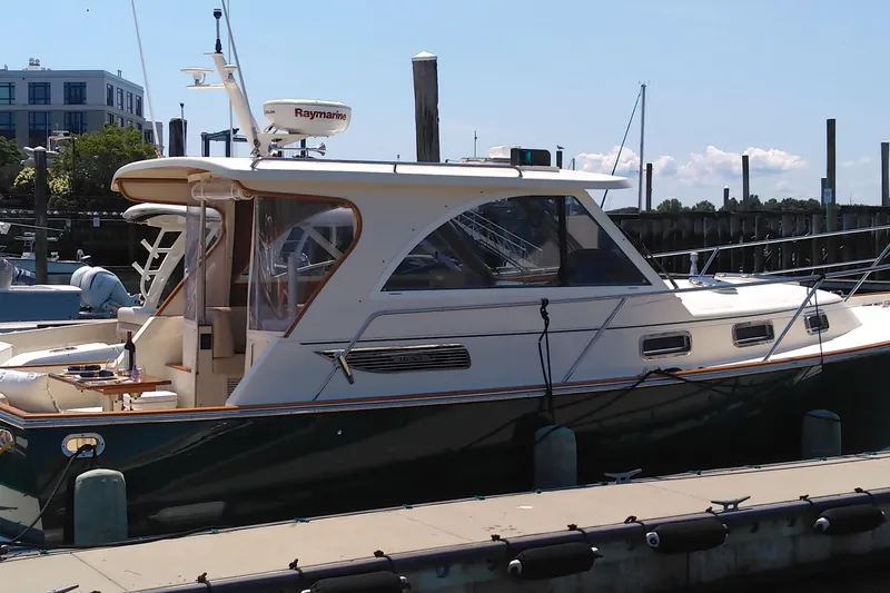 Slide: The Image of 2008 Legacy Yachts 32 docked at marina, featuring classic design and modern amenities. - 36