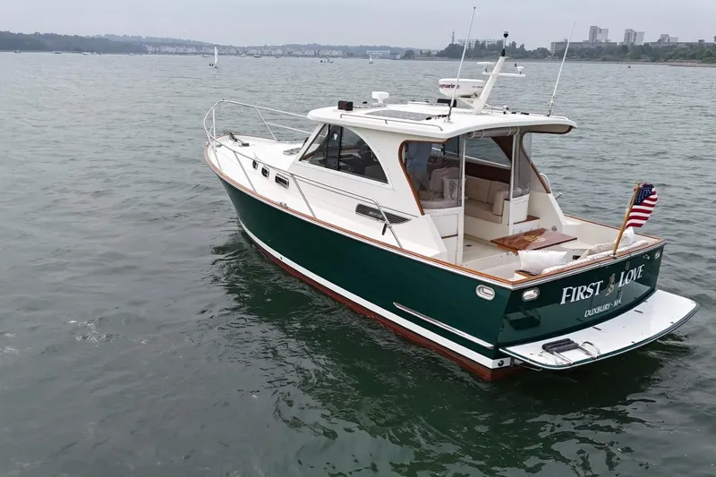 Slide: The Image of 2008 Legacy Yachts 32 boat named "First Love" on calm water. - 4