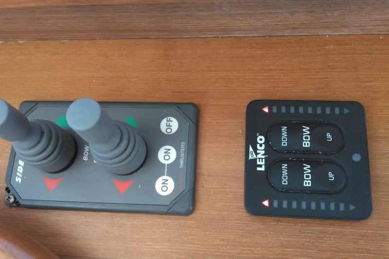 Slide: The Image of Control panel of a 2008 Legacy Yachts 32, featuring thruster and trim tab controls. - 43