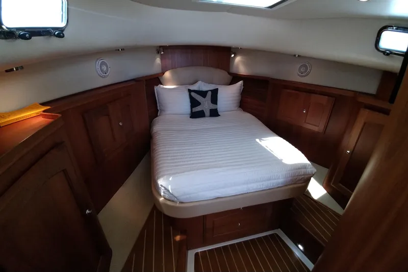 Slide: The Image of Luxurious cabin interior of 2008 Legacy Yachts 32 with cozy bed and wooden finish. - 48