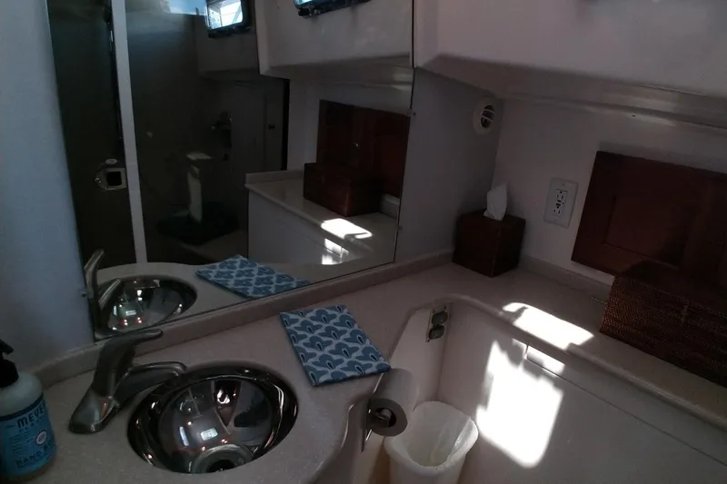 Slide: The Image of Bathroom interior of 2008 Legacy Yachts 32, featuring sink, mirror, and storage. - 53