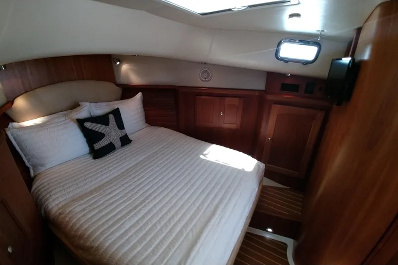 Slide: The Image of Luxurious cabin interior of 2008 Legacy Yachts 32 with cozy bed and wooden finish. - 55