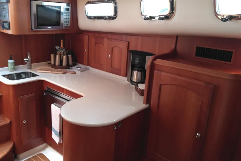 Slide: The Image of 2008 Legacy Yachts 32 interior kitchen with wood cabinetry and modern appliances. - 56