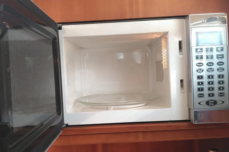 Slide: The Image of Open microwave oven inside a 2008 Legacy Yachts 32, showcasing control panel and interior. - 63