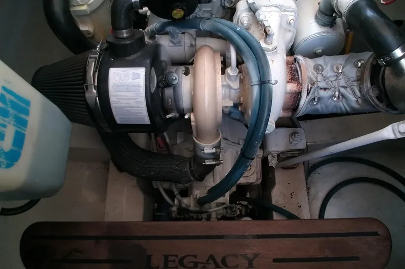 Slide: The Image of Engine compartment of a 2008 Legacy Yachts 32, showcasing mechanical components and branding. - 69